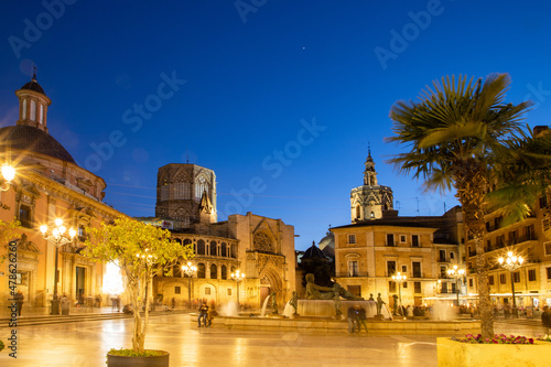 VALENCIA , SPAIN - DECEMBER 6, 2021: Square of Saint Mary's with Valencia Cathedral Temple, Basilica de la nuestra senora de los desamparados and the rio tura fountain in old town. photo