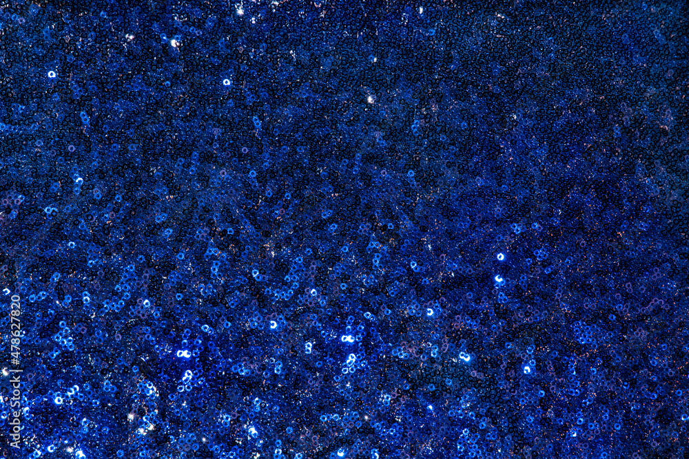 Blue fabric texture with sequins and metallic shiny. holiday sparkling textile with sequins. Blue sparkling abstract background from metallic sequins. Dark blue fish scale sequin fabric Blue fabric texture with sequins and metallic shiny. holiday sparkling textile with sequins. Blue sparkling abstract background from metallic sequins. Dark blue fish scale sequin fabric