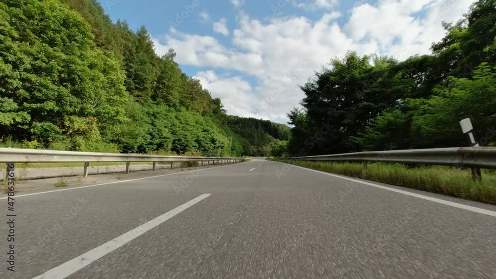 Winding car journey on beautiful German country road in summer