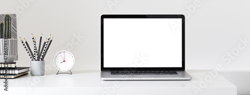 Laptop with blank screen on a table. 