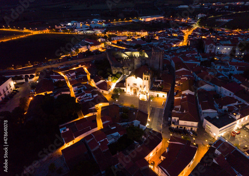 Night aerial view of Portuguese city of Sepra with medieval fortified Castle and illuminated clock tower