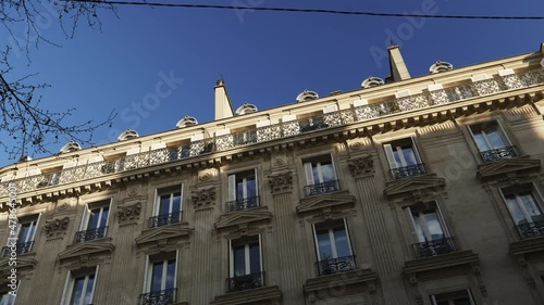 Slow panning to luxury apartment building Haussmannian architecture in central Paris - real estate immo property in central part of the city near Champs Elysee - large French balconies