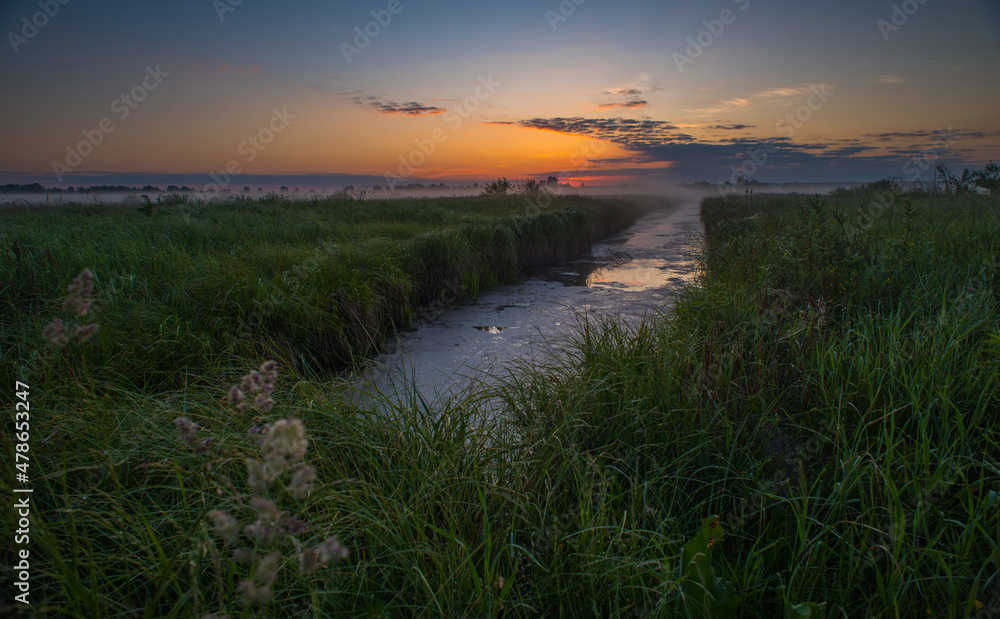 Dawn of the sun against the background of the river and reeds.. Dawn of the sun against the background of the river and reeds..
