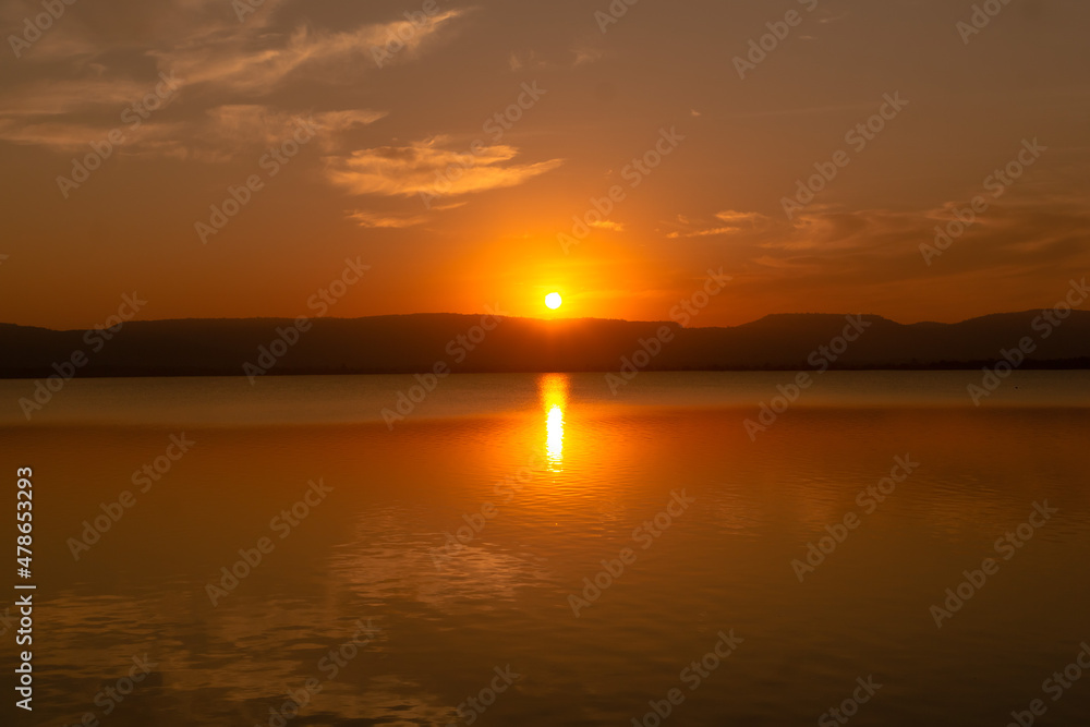 autumn river landscape in Thailand,sunset shines over a blue water lake or river.beautiful orange sunset