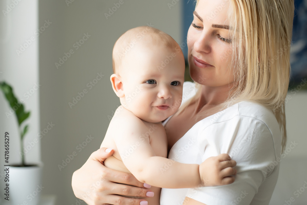 Portrait of a mother with her 6 months old baby, top view point Portrait of a mother with her 6 months old baby, top view point