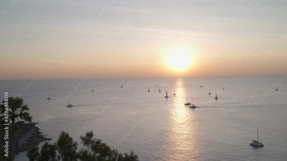 panorama aerial view of seascape in sunset evening from tourist photography point. taking photo of sunset dawn at cape, luxury sailboat sailing in sea. summer sun tropical vibe copy space provided. panorama aerial view of seascape in sunset evening from tourist photography point. taking photo of sunset dawn at cape, luxury sailboat sailing in sea. summer sun tropical vibe copy space provided.