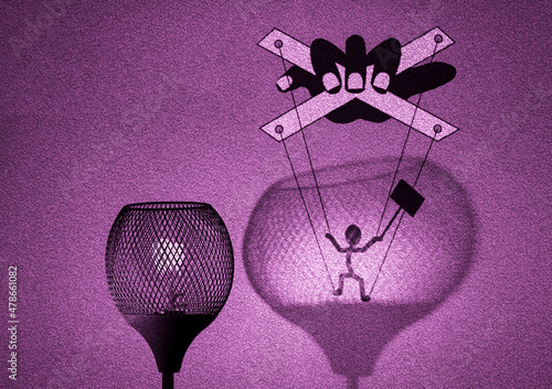 Gaslight with silhouette of puppet on strings being manipulated by a hand in shadow cast by the lamp on wall, political gaslighting concept illustration photo