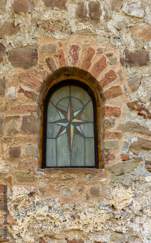 window in the old wall of church