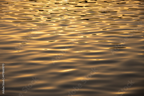 Beautiful golden ripples of the sea water at sunset