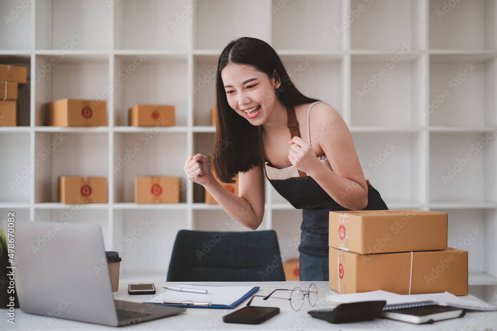 Business owner excite when got an order from her online shop. Successful SME entrepreneur concept. Business owner excite when got an order from her online shop. Successful SME entrepreneur concept.