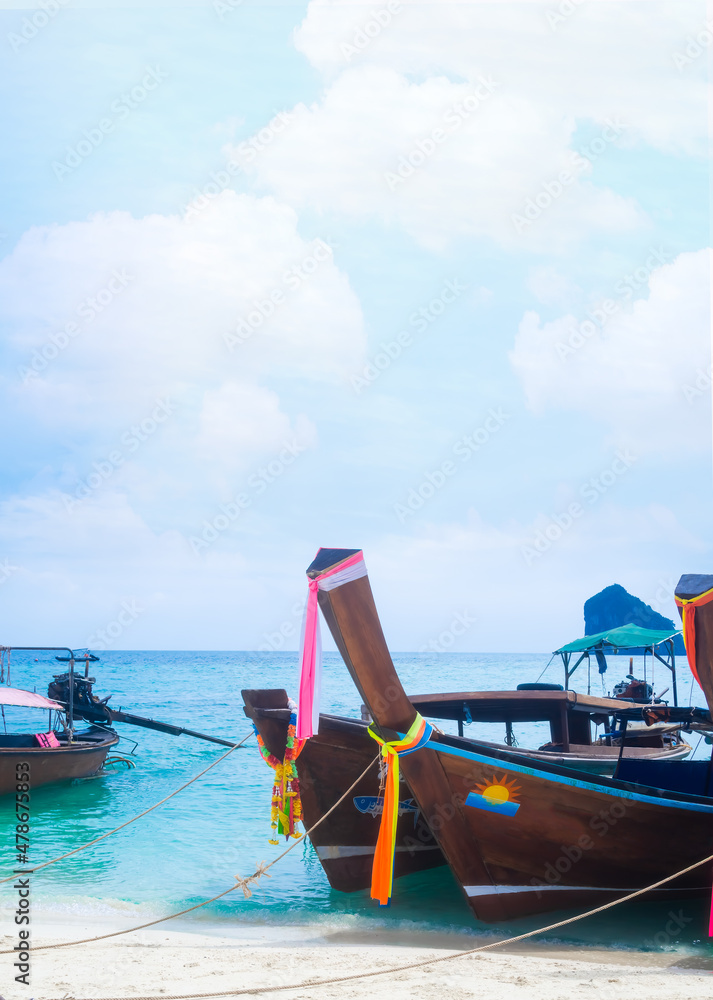 Boat on sand beach at coast with blue sea and blue sky. portrait with free space. Ocean in Thailand. tourism vacation tropical summer in holidays concept.