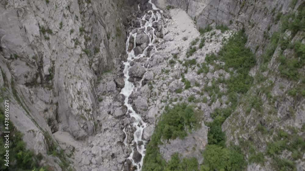Video of a flat drone view of a descriptive ascending bird over the river of the Boka cascasa and the cascaca on the horizon in Slovenia Video of a flat drone view of a descriptive ascending bird over the river of the Boka cascasa and the cascaca on the horizon in Slovenia