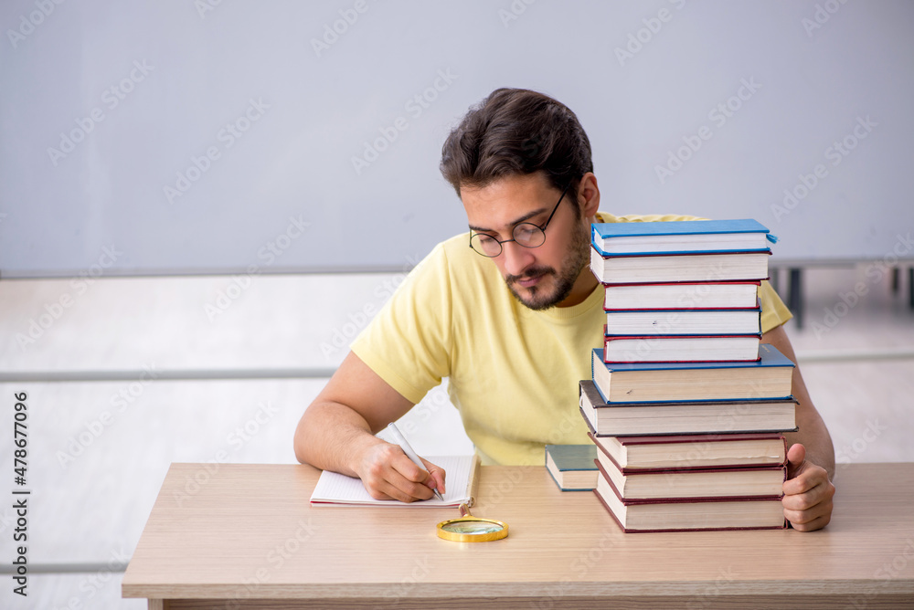 Young male student preparing for exams in the classroom Young male student preparing for exams in the classroom