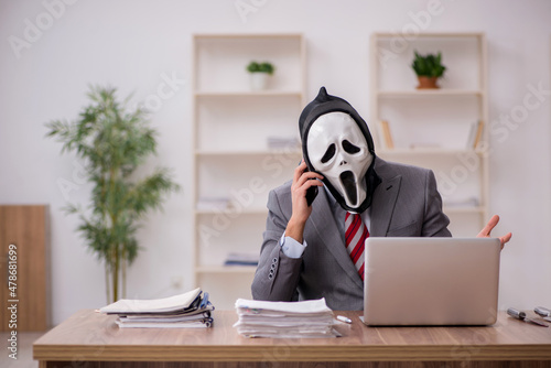 Fotografia Devil businessman employee sitting at workplace