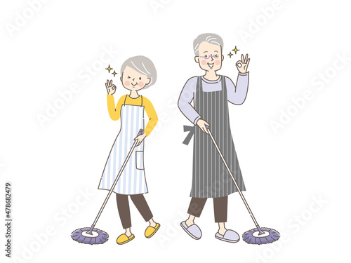 フローリングを掃除する笑顔のシニア夫婦