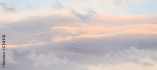 Background of blue sky with white and pink clouds in sunset