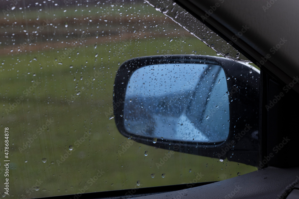 Car side glass with rain drops