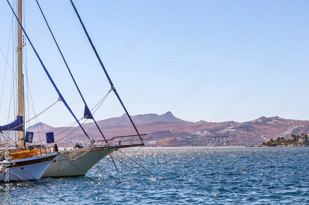 Sailboats in the blue sea against the backdrop of islands and mountains Sailboats in the blue sea against the backdrop of islands and mountains