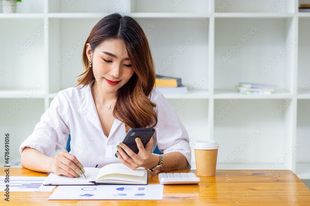 Businesswoman looking at last year's company sales data on the phone, woman sitting in a chair looking at financial documents, accountant checking company numbers, new business concept.