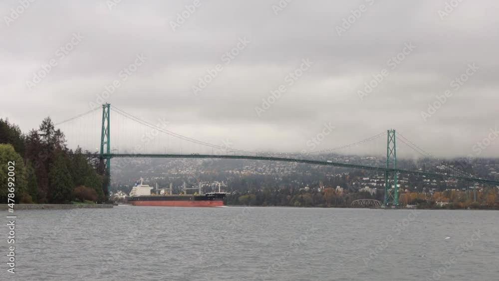 Stationary Shot of Cargo Ship Passing Under Lionsgate Bridge Stationary Shot of Cargo Ship Passing Under Lionsgate Bridge
