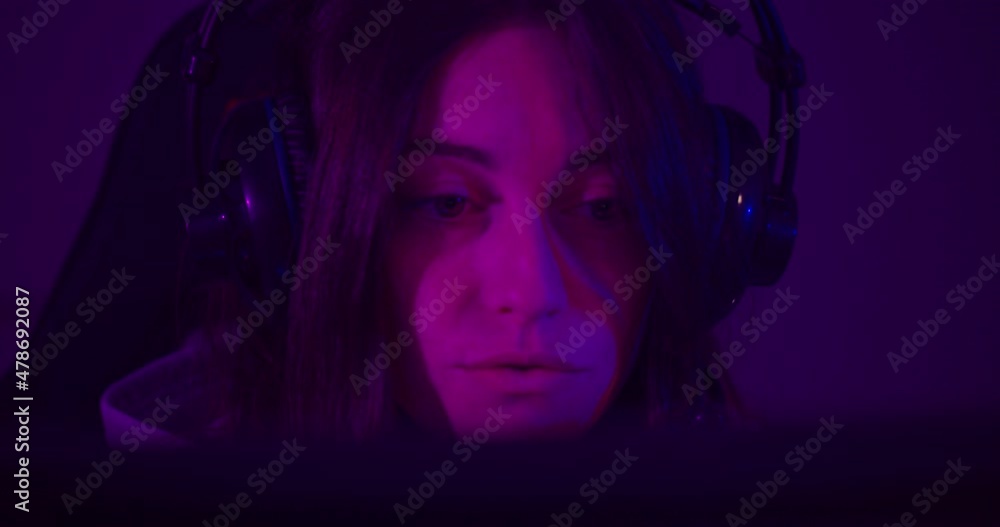 European Woman In Headset Communicating Through Video Call On A Computer At Home Office. close up European Woman In Headset Communicating Through Video Call On A Computer At Home Office. close up