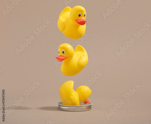 Tableau sur toile Yellow rubber ducks fly from top to bottom one by one and fall in  pipe