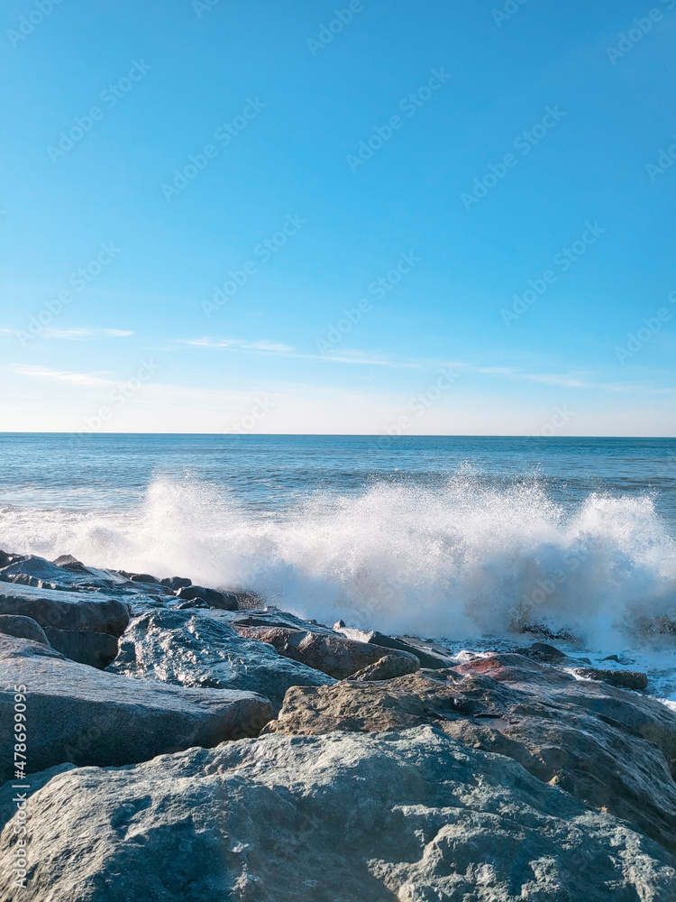 Seascape of rocky beach. Sea waves crash and splash on rocks. View of the sea, ocean. Natural soft blue background. View of the black sea, Batumi 