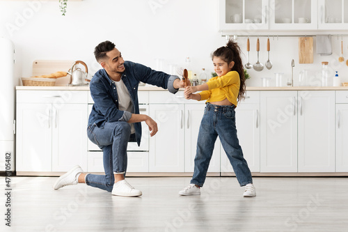 Cheerful Young Middle-Eastern Man Having Fun At Home With His Little Daughter