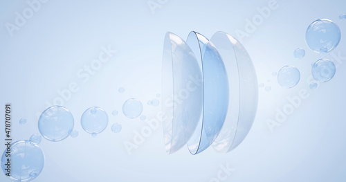 Fotografie Contact lenses in water surface with air bubbles on blue background
