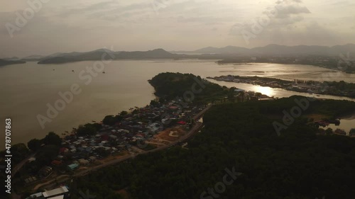 The replica of Phra That In-Kwaen (Hanging Golden Rock) with Sunset background, Sirey temple, Phuket, Thailand. photo