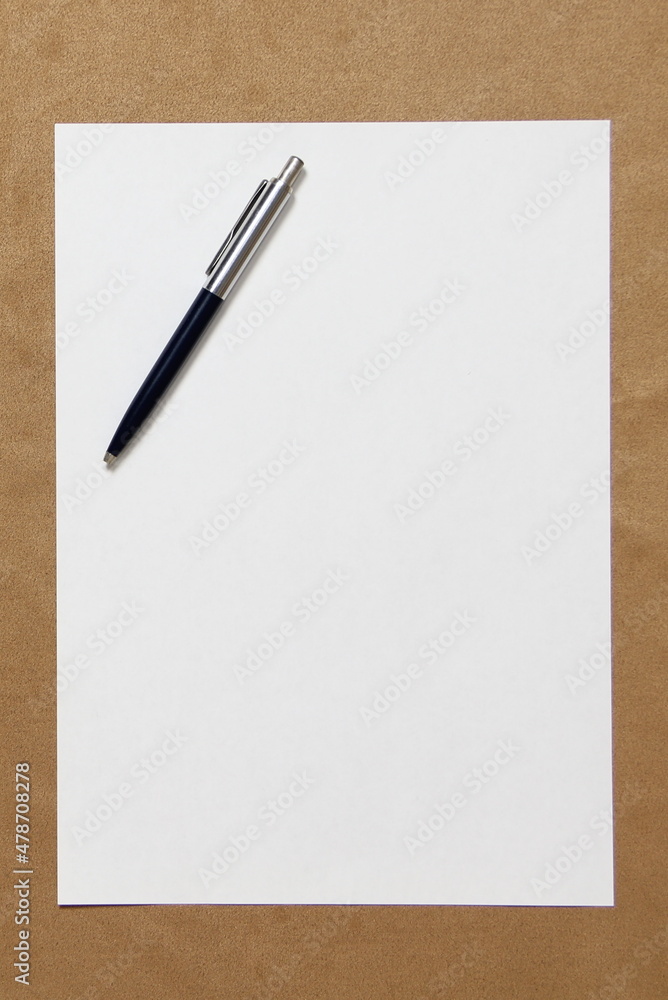 Template of white paper with pen lies on light brown cloth background. Concept of business plan and strategy. Stock photo with empty space for text and design. Template of white paper with pen lies on light brown cloth background. Concept of business plan and strategy. Stock photo with empty space for text and design.