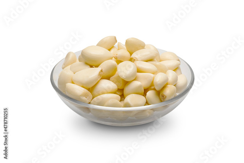 Peeled garlic in a glass bowl isolated on white background. Clipping path.