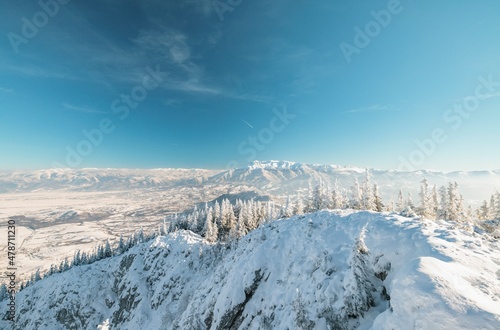 Climbing Piatra Mică Peak may be difficult, but the view from the top is beautiful. Piatra Craiului National Park from Romania. People hiking in winter mountains for winter sport snow mountain hills