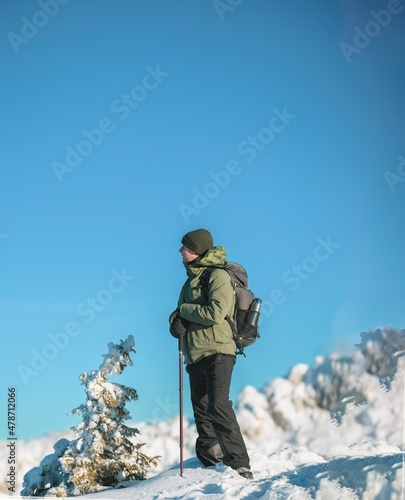 People hiking in beautiful winter mountains for winter sport activity snow mountain hills. Going for hikes in the winter for winter sports like winter hiking and cross-country skiing is very rewarding