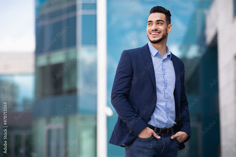 Fototapeta premium Young arab man standing by business center
