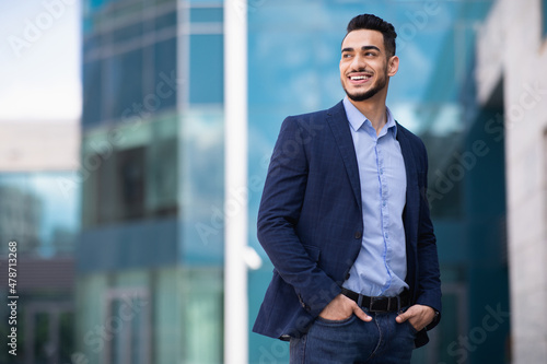 Young arab man standing by business center