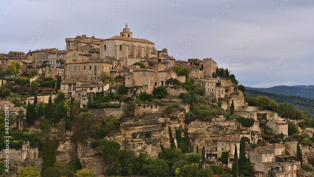 Beautiful view of the upper part of popular village Gordes located on a rocky hill above Luberon valley in Provence, France with characteristic houses.