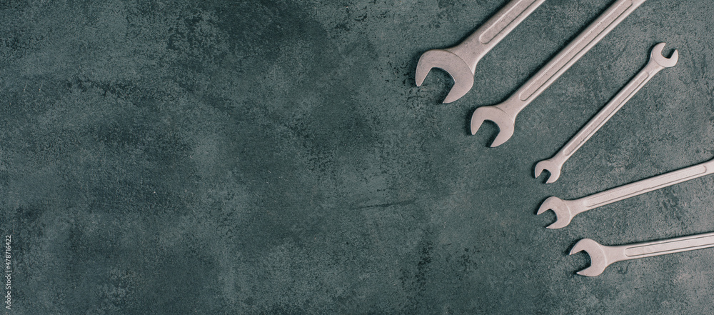 Wrenches tools on a dark textured background, copy space for text, repair and construction works, Labor Day - obrazy, fototapety, plakaty 
