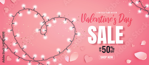 Valentine's Day sale banner. Romantic composition with hearts, petals and a garland on a pink background. Vector illustration for website , posters,ads, flyers and other promotional material.