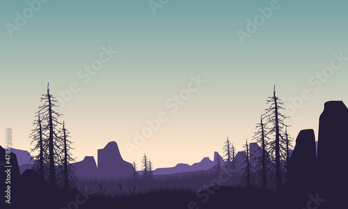 Aesthetic view of mountains and lake with dry tree silhouettes from out of town at sunrise