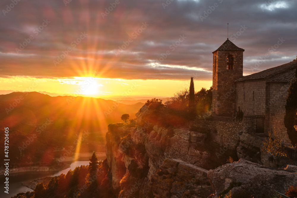 View of the Romanesque church of Santa Maria de Siurana on the cliff at sunset, Siurana, Tarragona, Catalonia