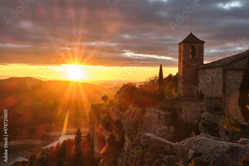 View of the Romanesque church of Santa Maria de Siurana on the cliff at sunset, Siurana, Tarragona, Catalonia