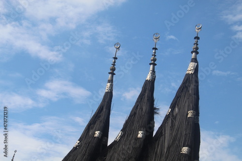Roof of Minangkabau traditional house (Rumah Gadang), West Sumatra Ethnic, Indonesia, Asia on cloudy sunny bright sky