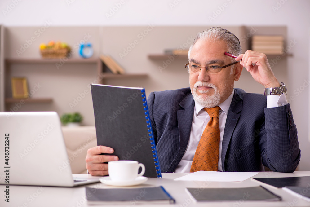 Old male employee working from home during pandemic Old male employee working from home during pandemic