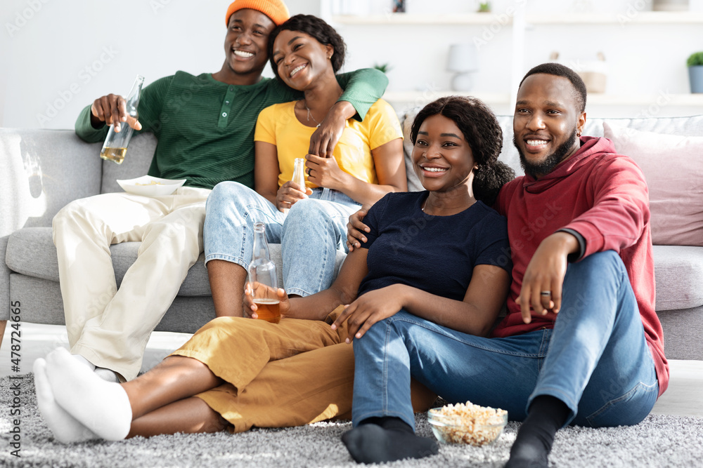 Two loving black couples watching romantic movie at home Two loving black couples watching romantic movie at home