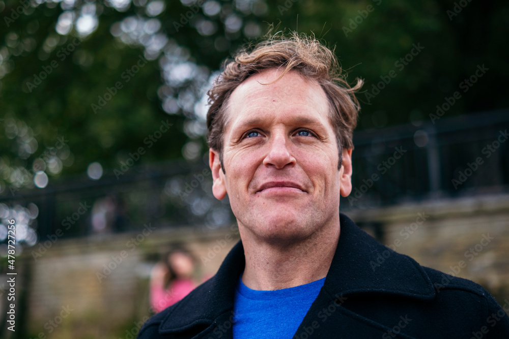 Smiling man wearing jacket looking away Smiling man wearing jacket looking away