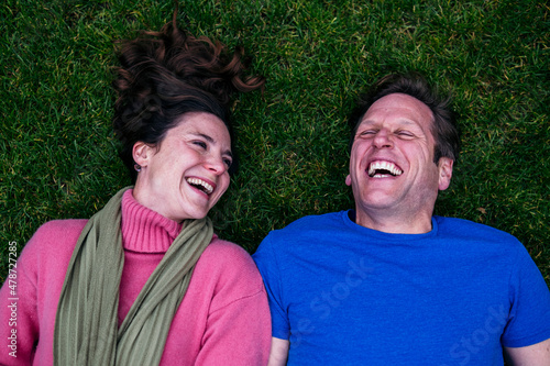 Cheerful couple lying on grass photo