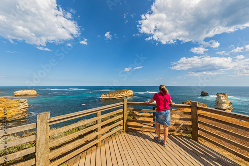 Australia, Victoria, Female tourist admiring Bay of Islands from observation deck photo