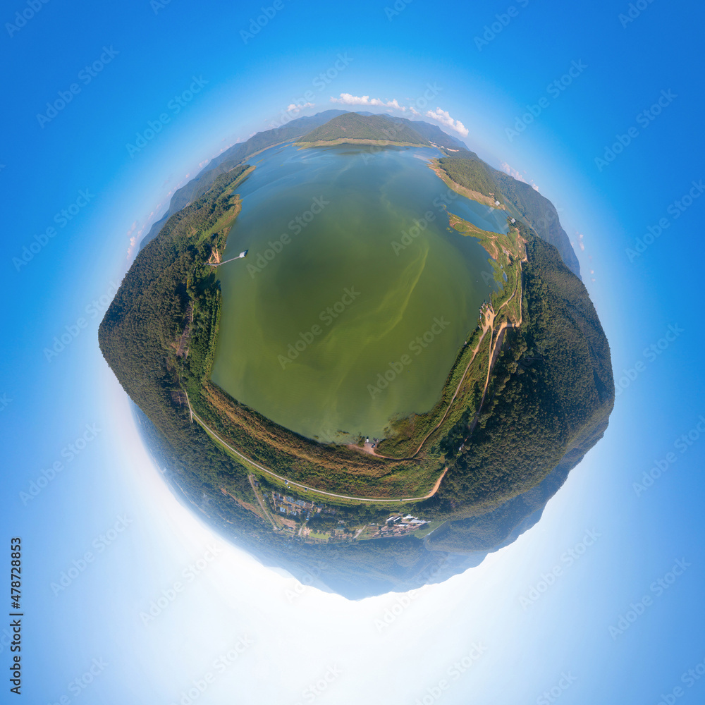 Fototapeta premium Little planet 360 degree sphere. Panorama of aerial top view of a dam with forest trees, lake, river, mountain hills in travel and environment concept. Nature landscape in Thailand.