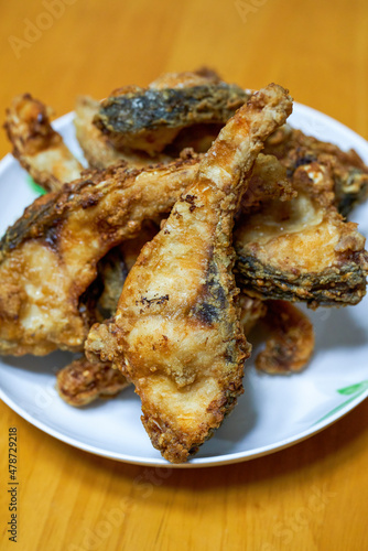 A plate of delicious fried grass carp belly closeup